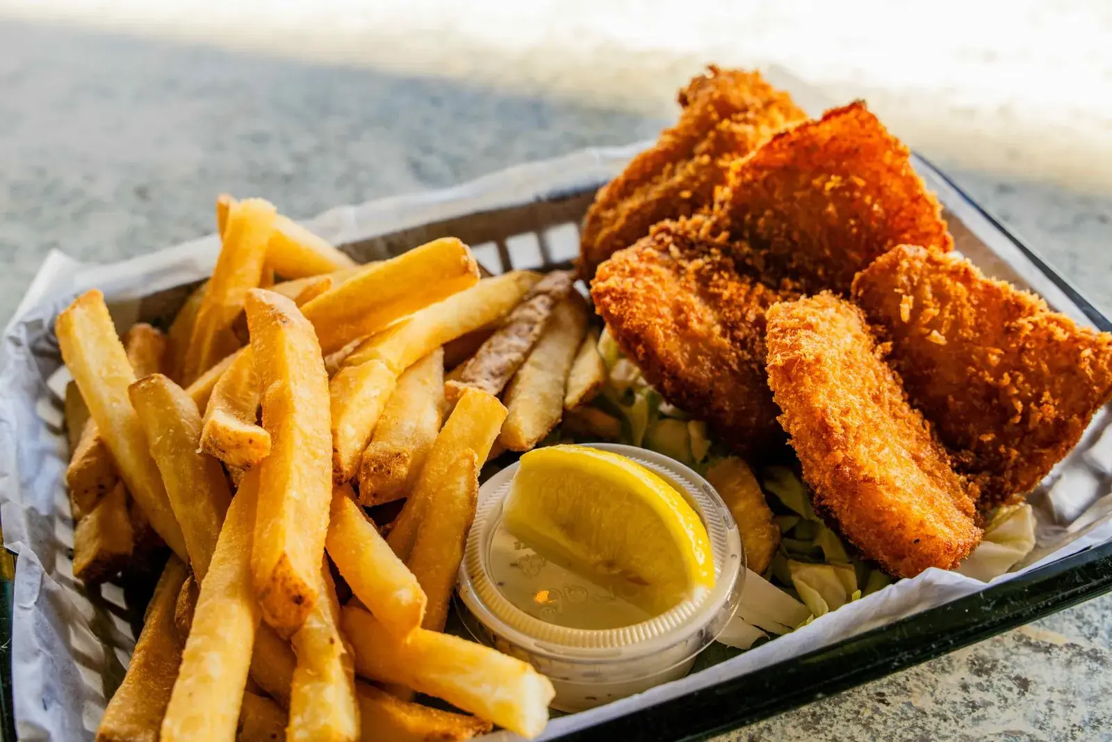 Beer-battered Fish & Chips basket with fries at Harbor House Kona