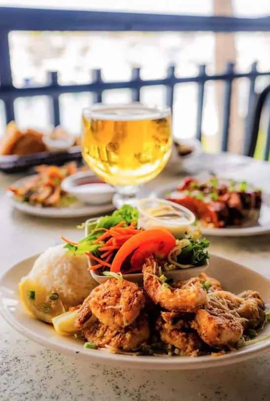 Garlic shrimp plate with rice and a cold beer at Harbor House Kona
