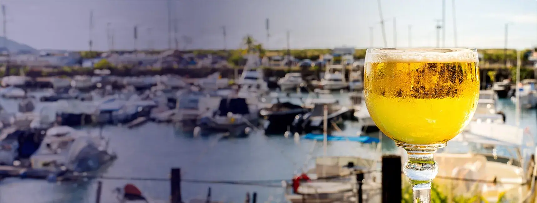 Ice-cold schooner of beer overlooking the boats of Honokohau Harbor at Harbor House Kona