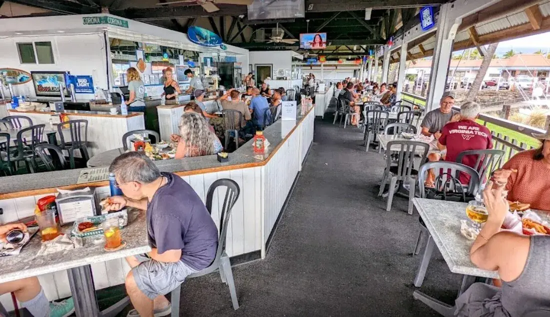 Open-air dining room overlooking Honokohau Harbor at Harbor House Kona