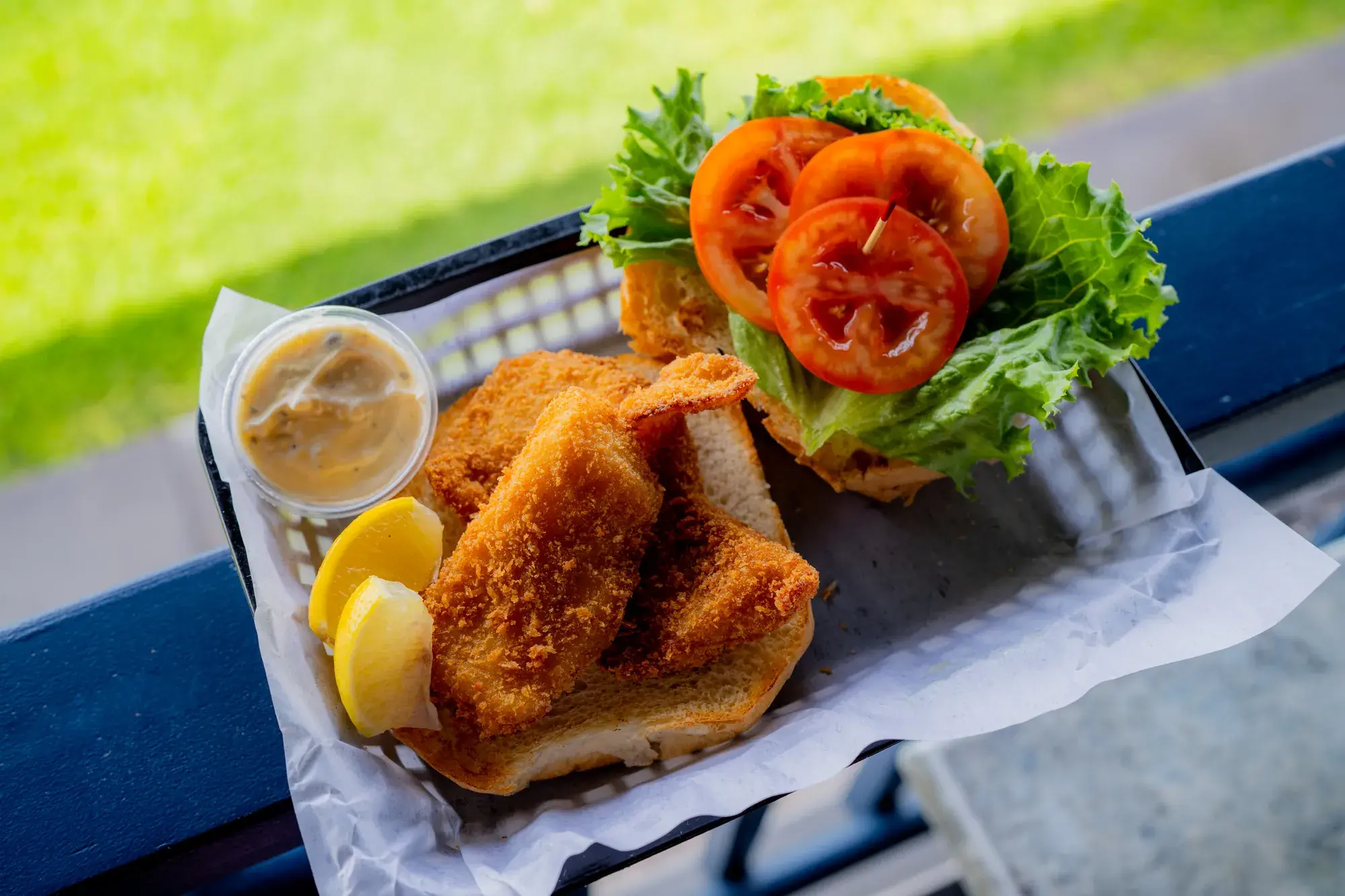 Fried Fish Sandwich at Harbor House Kona, Beer-battered fish, lettuce, & tomato.