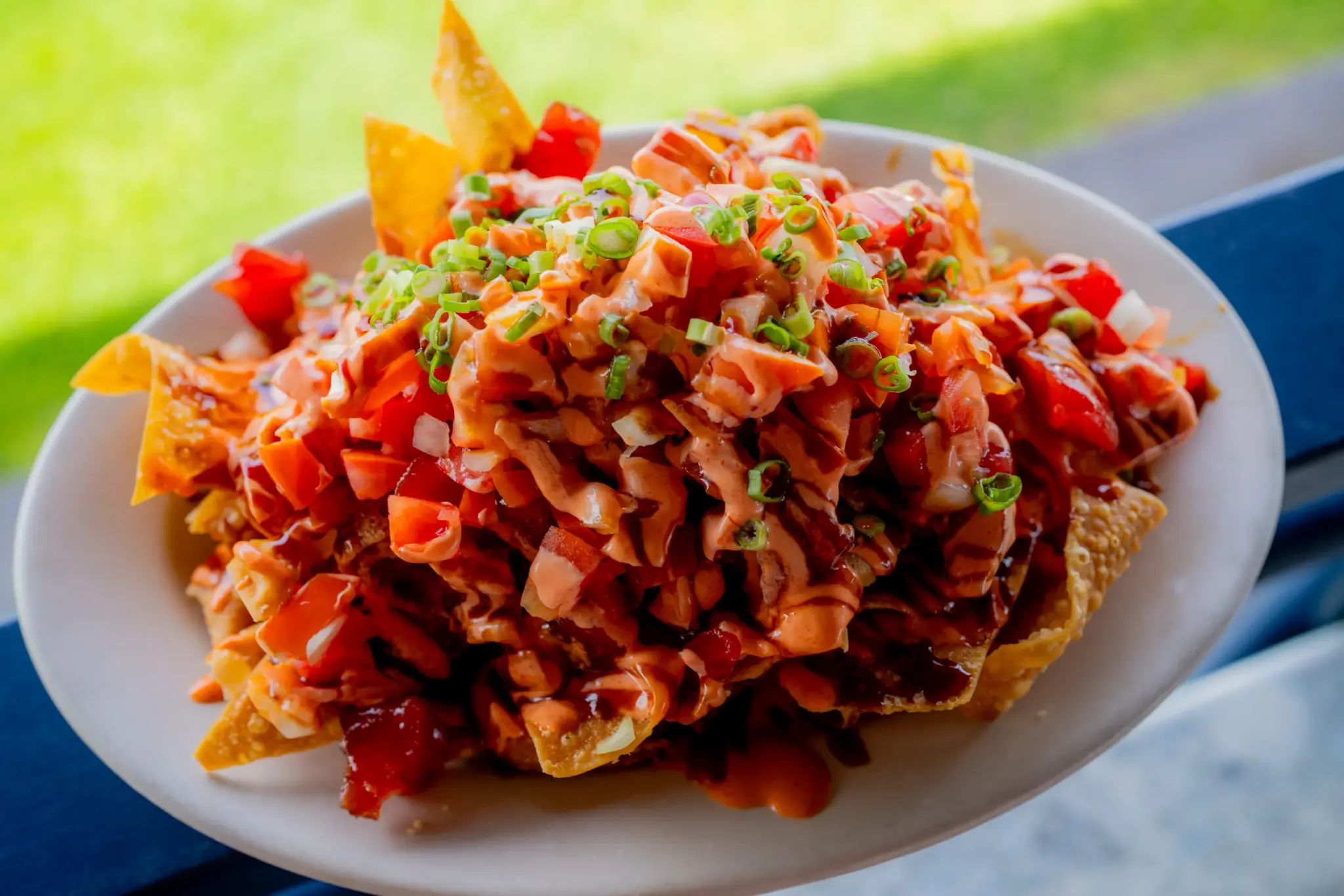 Poke Nachos at Harbor House Kona, Crispy wonton chips piled with ahi poke, sriracha aioli and unagi sauce.