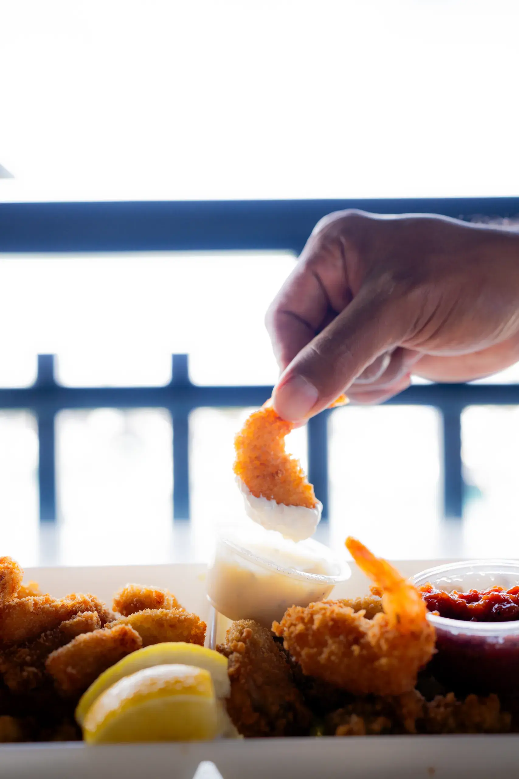 Shrimp & Chips at Harbor House Kona, Crispy panko-breaded shrimp with fries and your choice of side.