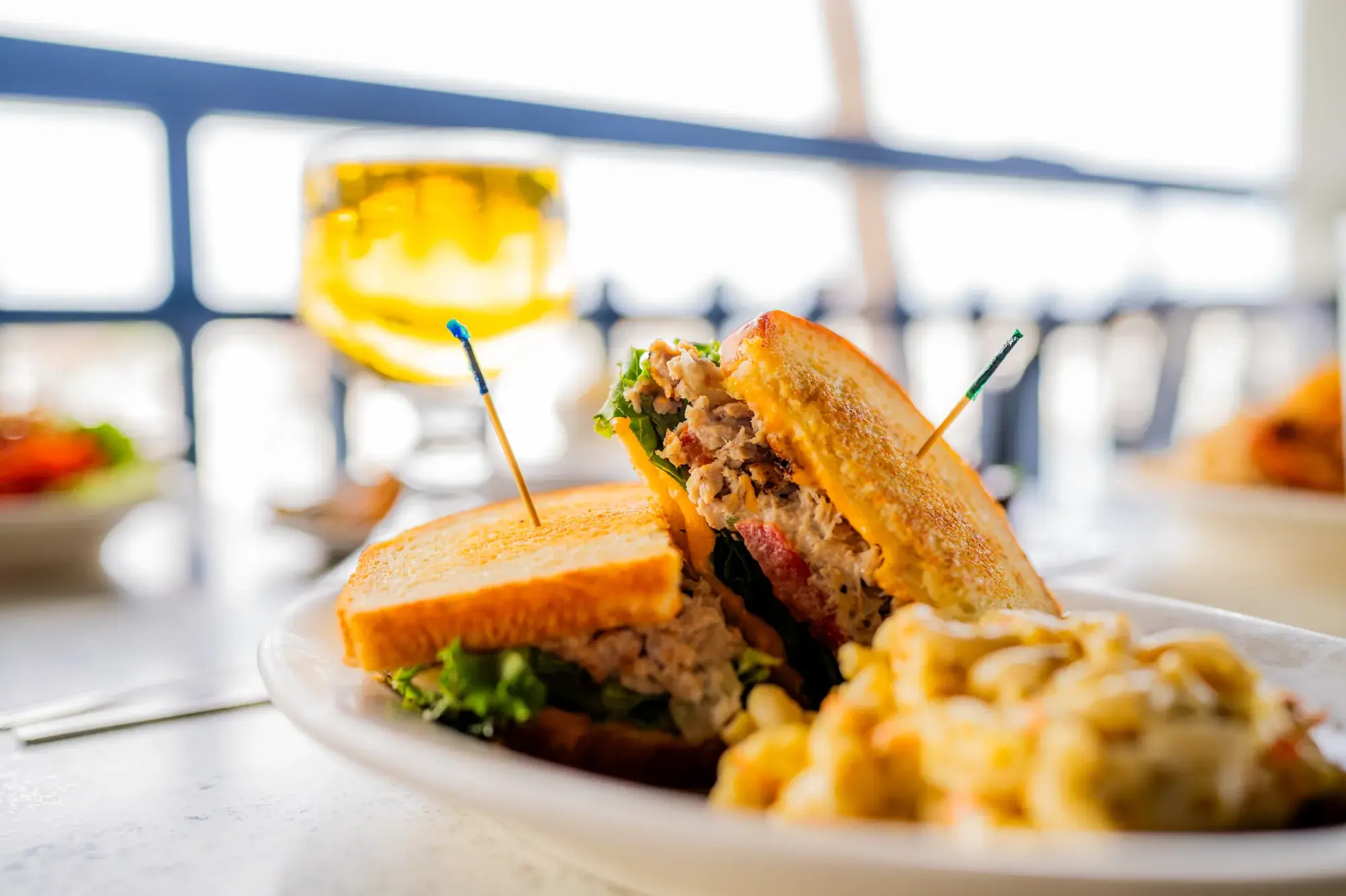 Tuna Melt Sandwich at Harbor House Kona, Cheddar cheese, lettuce, & tomato on toasted sourdough.