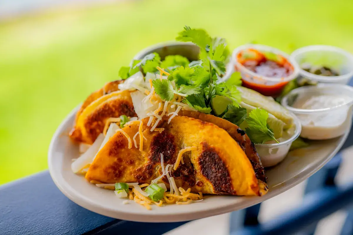 Crispy tacos with fresh garnish at the Harbor House rail