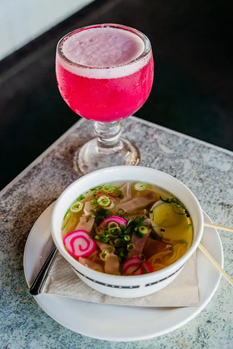 Pink li hing margarita served with a bowl of saimin at Harbor House Kona