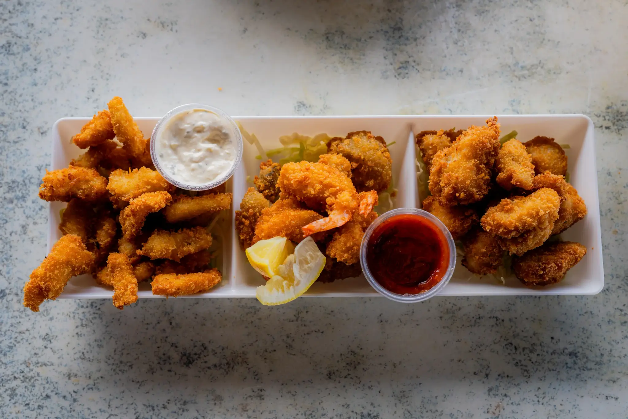 Deep Fried Seafood Combo at Harbor House Kona, Crispy calamari, shrimp, oysters and beer-battered fish on one platter.