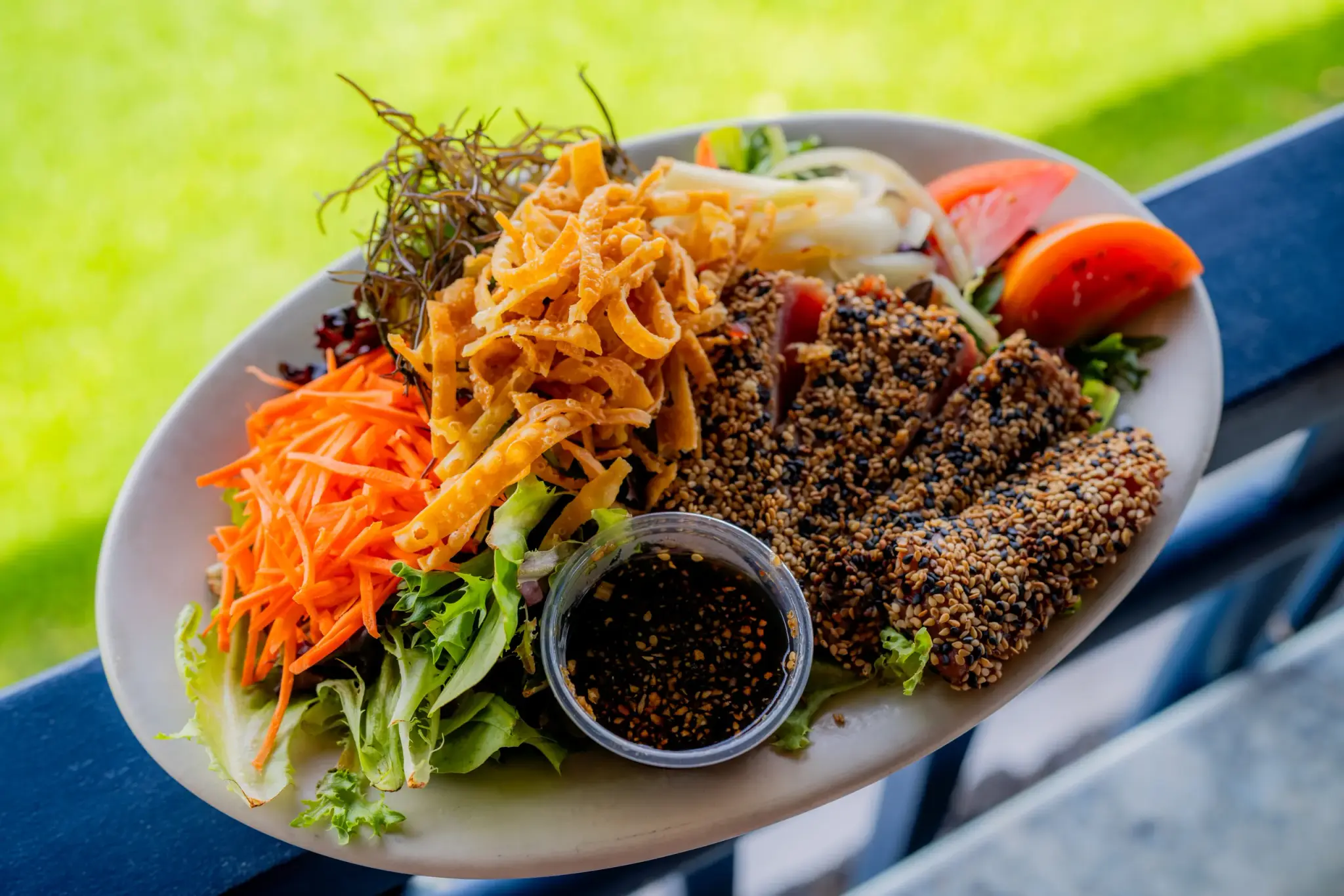 Sesame Ahi Salad at Harbor House Kona, Mix greens, pickled onions, ogo seaweed, tomatoes, carrots w/ sesame soy dressing.